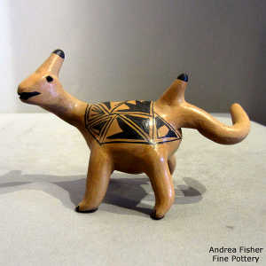 Geometric design in black on a brown dinosaur figure