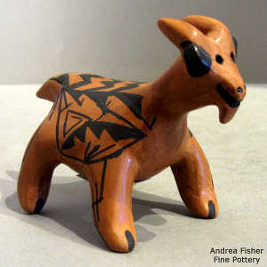 Geometric design on a black on brown goat figure