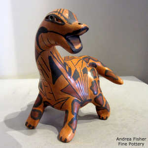 Geometric design on a polychrome dinosaur figure