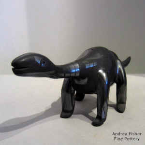 Geometric design on a black on black dinosaur figure