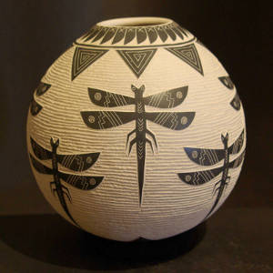 Sgraffito dragonflies and geometrics designs on a black jar