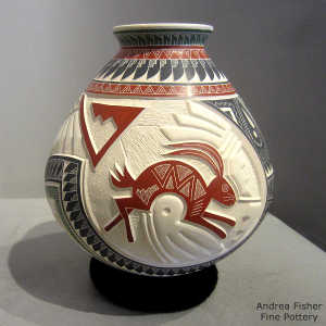 Lightly carved, sgraffito and painted rabbit, roadrunner and geometric design on a polychrome jar
