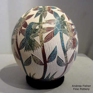 Sgraffito floral and hummingbird design on a polychrome jar