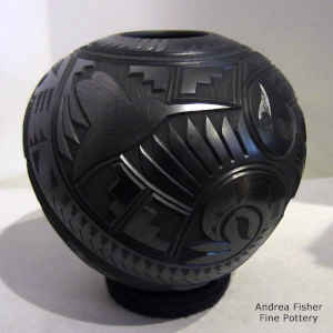 Black jar with a lightly carved and sgraffito hummingbird, lizard, flower and geometric  design