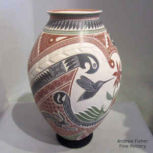 Polychrome jar with a lightly carved, sgraffito and painted hummingbird, serpent, rabbit, flower and geometric design