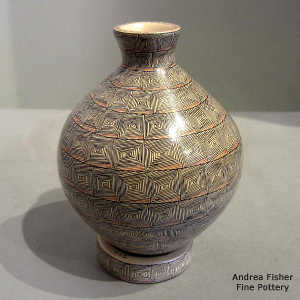 Geometric design on a polychrome thin neck vase with matching stand