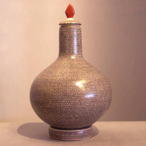 Intricate geometric design on a lidded tall neck jar