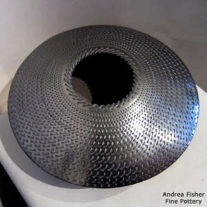 Textured surface finish on a flying saucer jar
