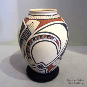 Lightly carved, sgraffito and painted geometric design on a polychrome vase