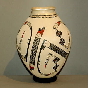 Sgraffito and painted geometric designs on a tan jar with a squared opening lip