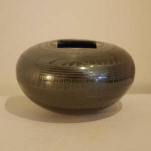 Bands of Paquime feather designs decorate a black on black jar with a square opening