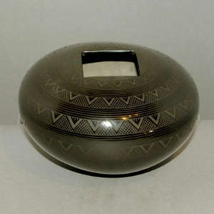 Bands of geometric design on a black on black jar with a square opening