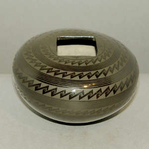 Geometric design and a square opening on a black on black jar