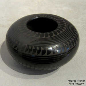 Bands of geometric design on a black on black jar