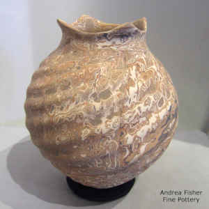 Squarish rim on a mixed clay jar with formed spiral ribs