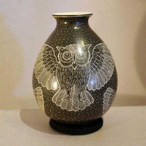 Sgraffito owl and night sky motif on a black and white jar