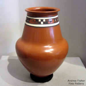 Lightly carved and painted band of geometric design on the neck of a polychrome vase