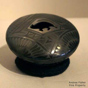 Paquime feather design and a stylized rabbit opening decorate a black on black seedpot