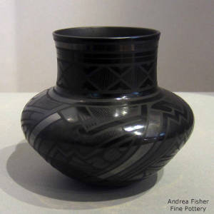 Fine line and geometric designs on a black on black jar