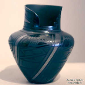 Geometric design on a black on black jar with a cut opening