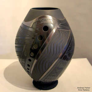 Light carving and geometric design on a black on black jar