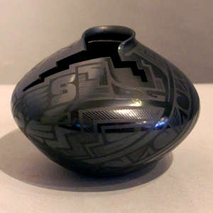 Geometric designs and a geometric cut opening on a black on black jar