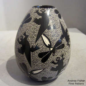 Sgraffito dragonfly, horned toad and mesh design on a black and white jar