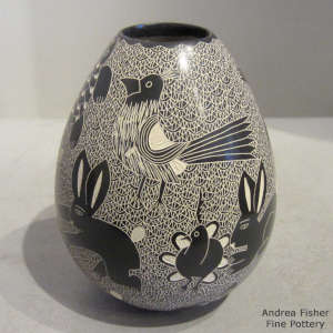 Sgraffito animal, reptile and bird motif on a black and white jar