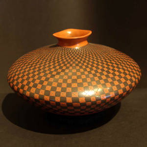 Square lip and a checkerboard design on a black and red jar