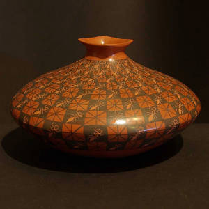 Checkerboard design and sgraffito ants on a red and black jar with a square lip