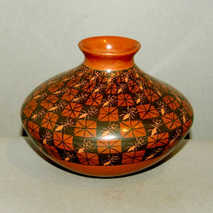 Geometric design and sgraffito ants on a black on red jar