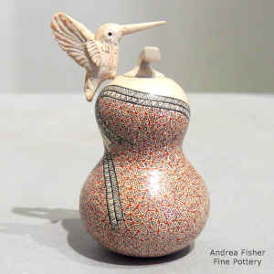 Miniature lidded polychrome jar with geometric design and sculpted hummingbird attachment
