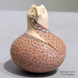 A geometric design on a miniature polychrome owl figure