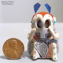 A geometric design on a miniature masked matachine figure