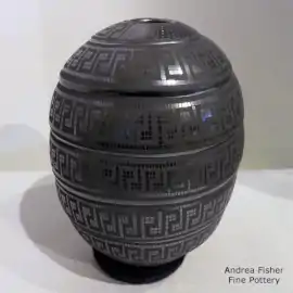 Ribbed design on a black-on-black seed pot decorated with a geometric design