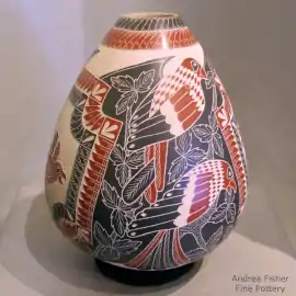 A sgraffito and painted elaborate bird and leaf design on a polychrome jar