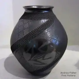 Black-on-black jar with a frog and geometric design plus bands of corrugation