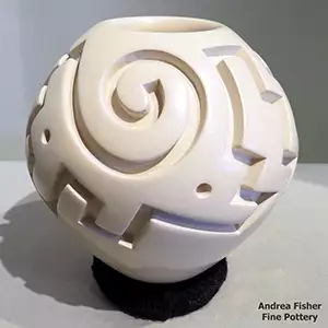 White jar carved with a spiral and geometric design