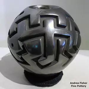 A geometric design carved into a black jar