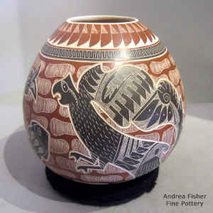 Polychrome jar decorated with a sgraffito and painted parrot, fish and geometric design