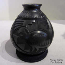 Black jar with a lightly carved and sgraffito parrot, hummingbird and geometric design