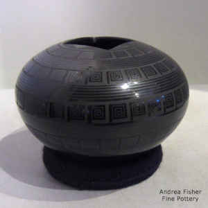 A geometric design on a black on black jar