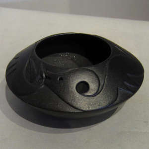Raised avanyu design on a micaceous black jar
