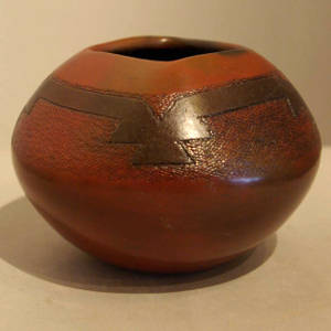 Navajo rug design on a brown jar