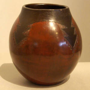 Navajo rug design on a brown jar