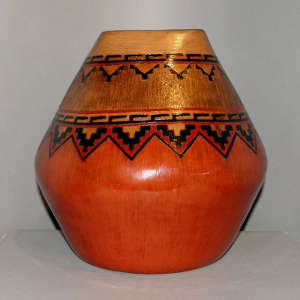 Band of Navajo carpet design around the rim of a large brown jar