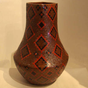 Navajo rug design and pine pitch coating on a tall neck jar