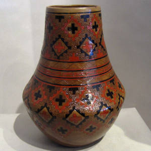 Navajo rug design and pine pitch coating on a tall neck brown jar