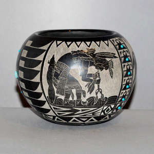 Sgraffito Sioux design plus inlaid stones on a black jar