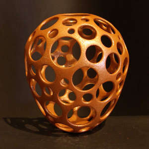 Perforated sculptural piece in orange micaceous clay